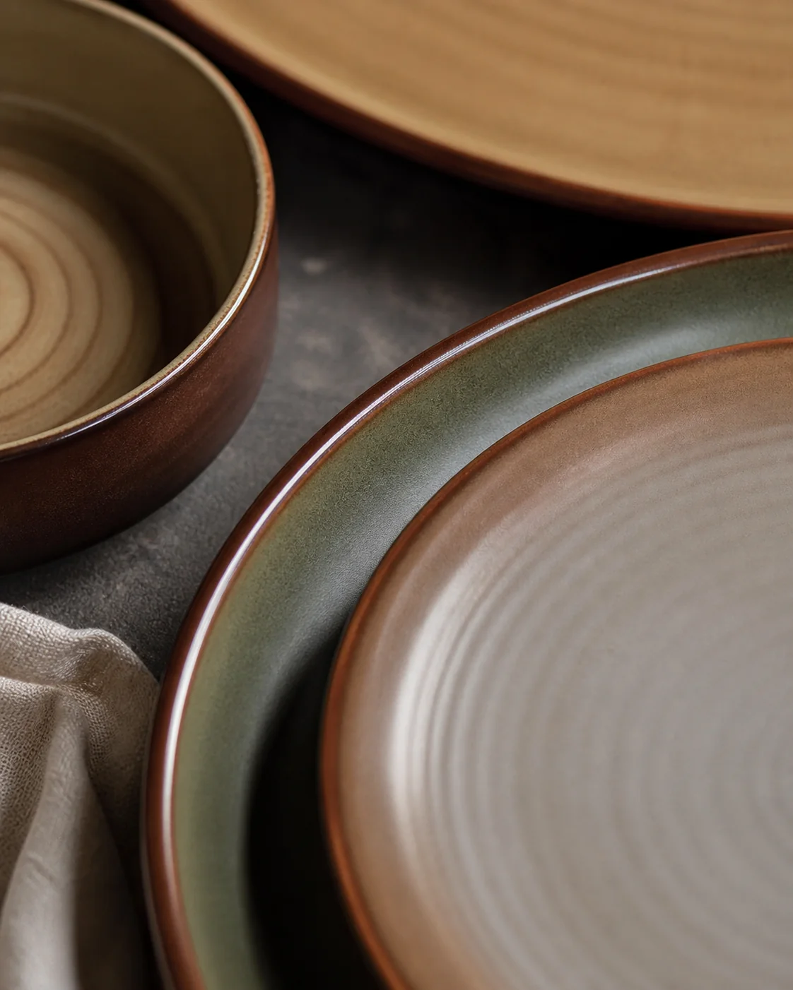 Earth-tone plates in brown and olive colouring - surface and colour detail