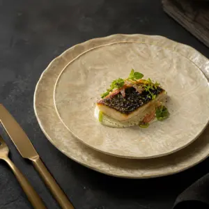 Cream and gold marble-effect presentation plates - styled table scene