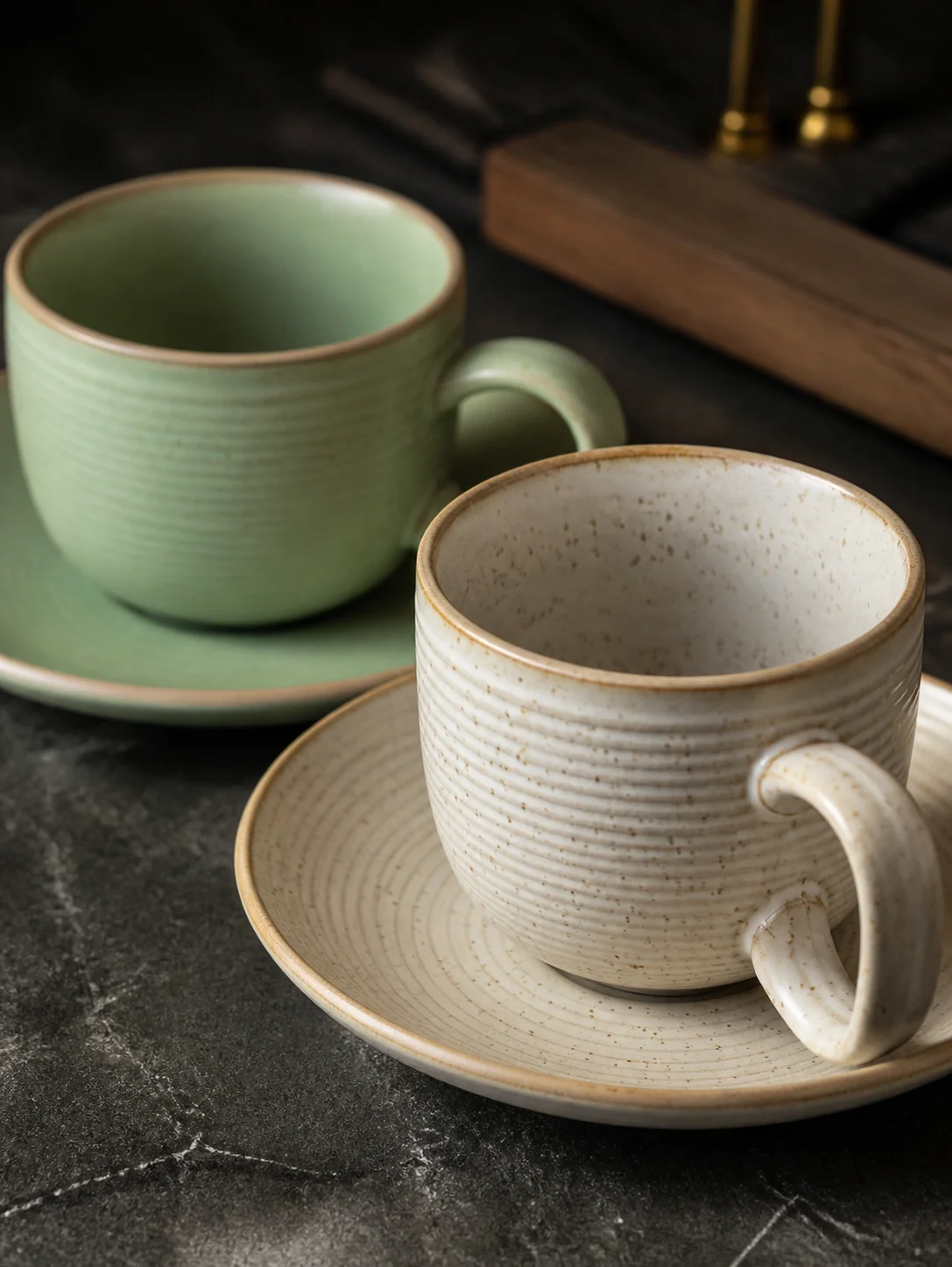 Sage green and cream tableware with plates and cups - surface and colour detail