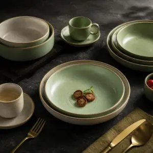 Sage green and cream tableware with plates and cups - styled table scene