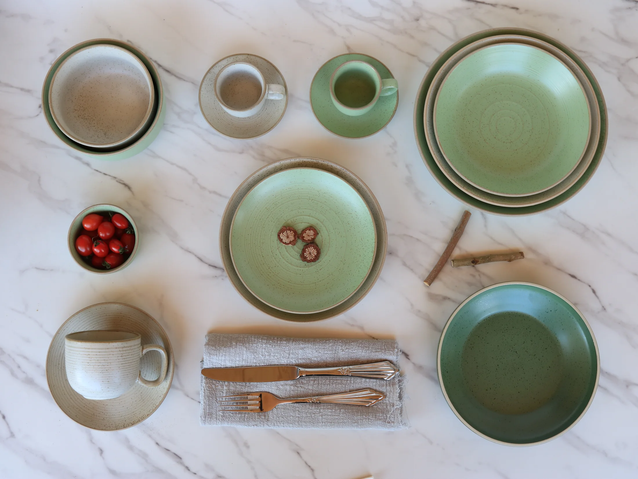 Sage green and cream tableware with plates and cups - product photograph