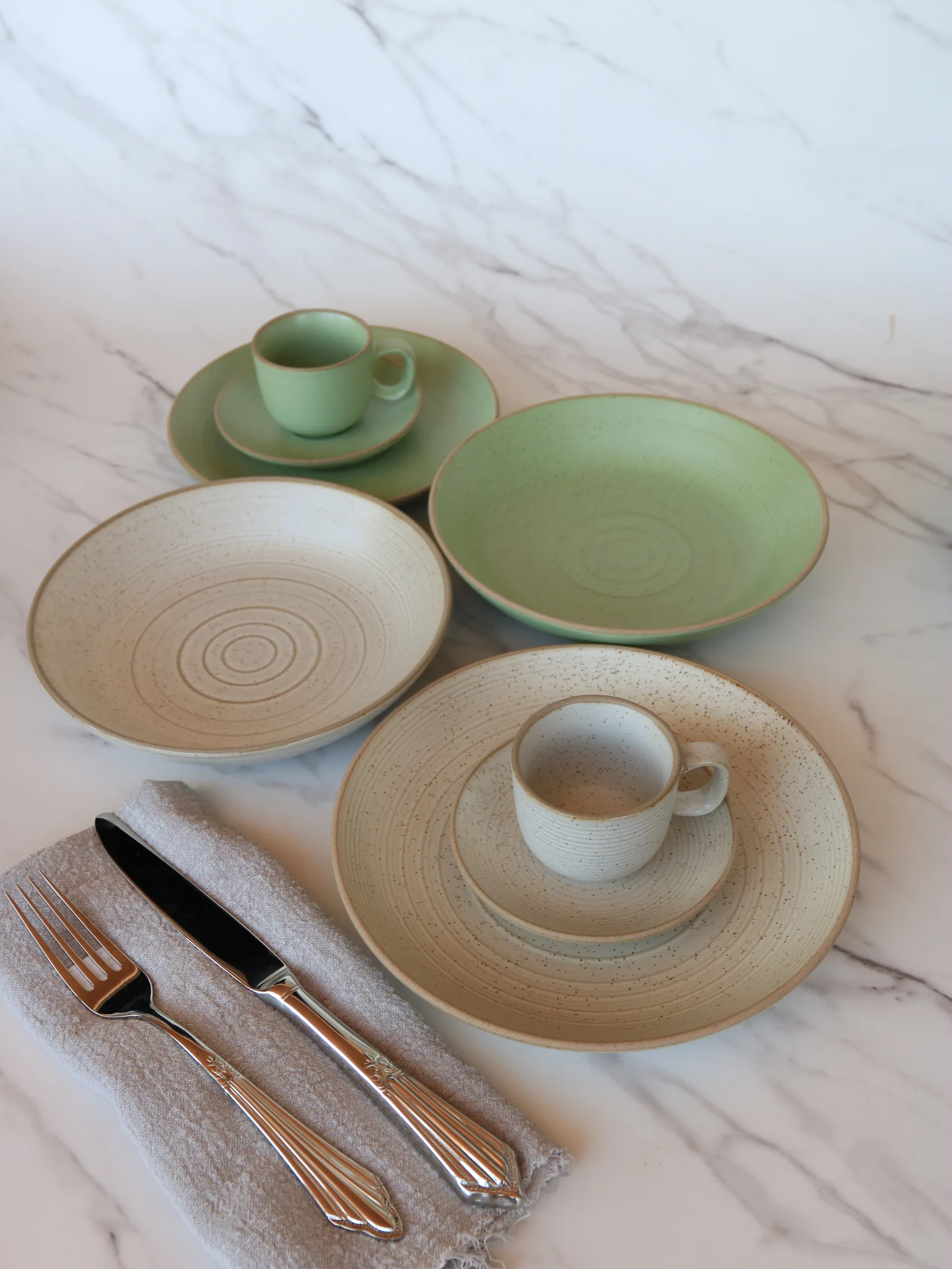 Sage green and cream tableware with plates and cups - product photograph