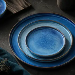 Blue and turquoise display plates with multi-tonal surface effects - styled table scene