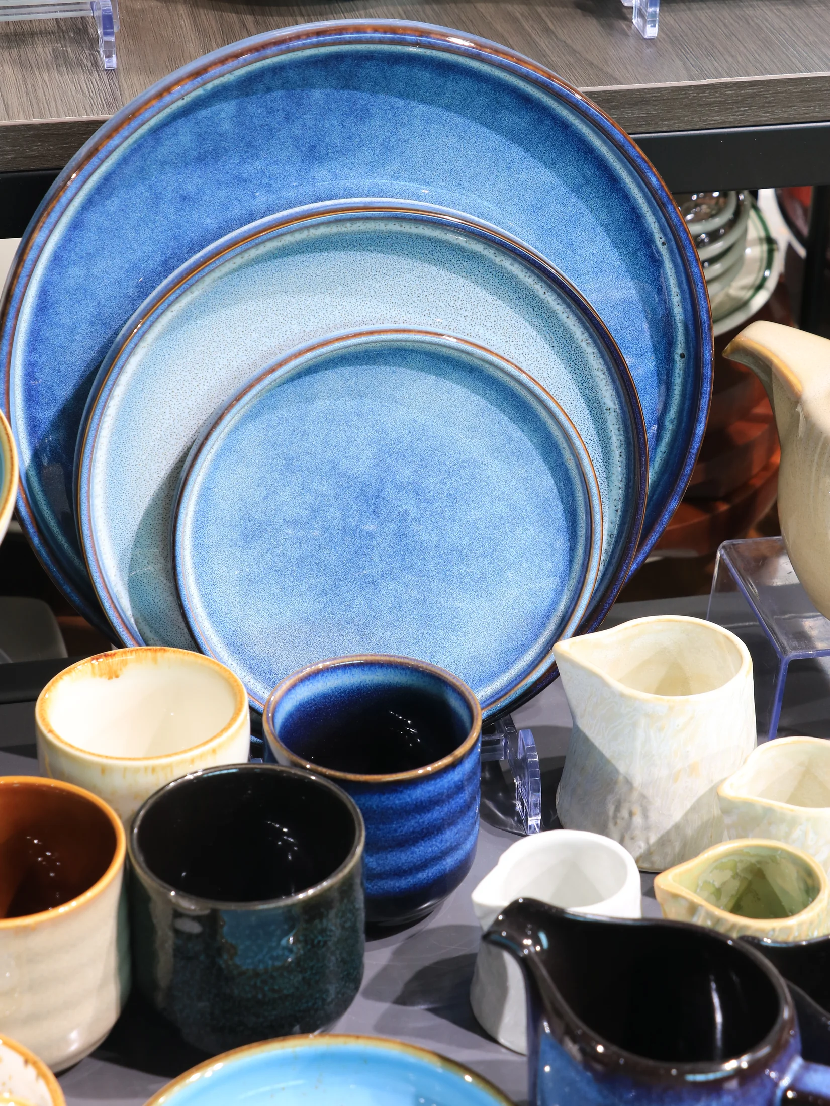 Blue and turquoise display plates with multi-tonal surface effects - product photograph