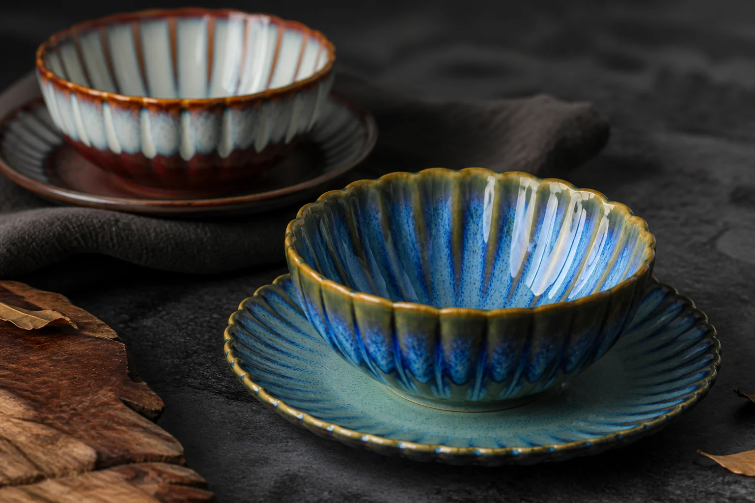 Ribbed cups and saucers in green and blue colouring - surface and colour detail