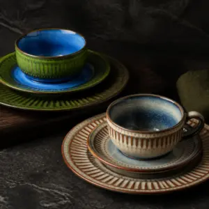 Ribbed cups and saucers in green and blue colouring - styled table scene