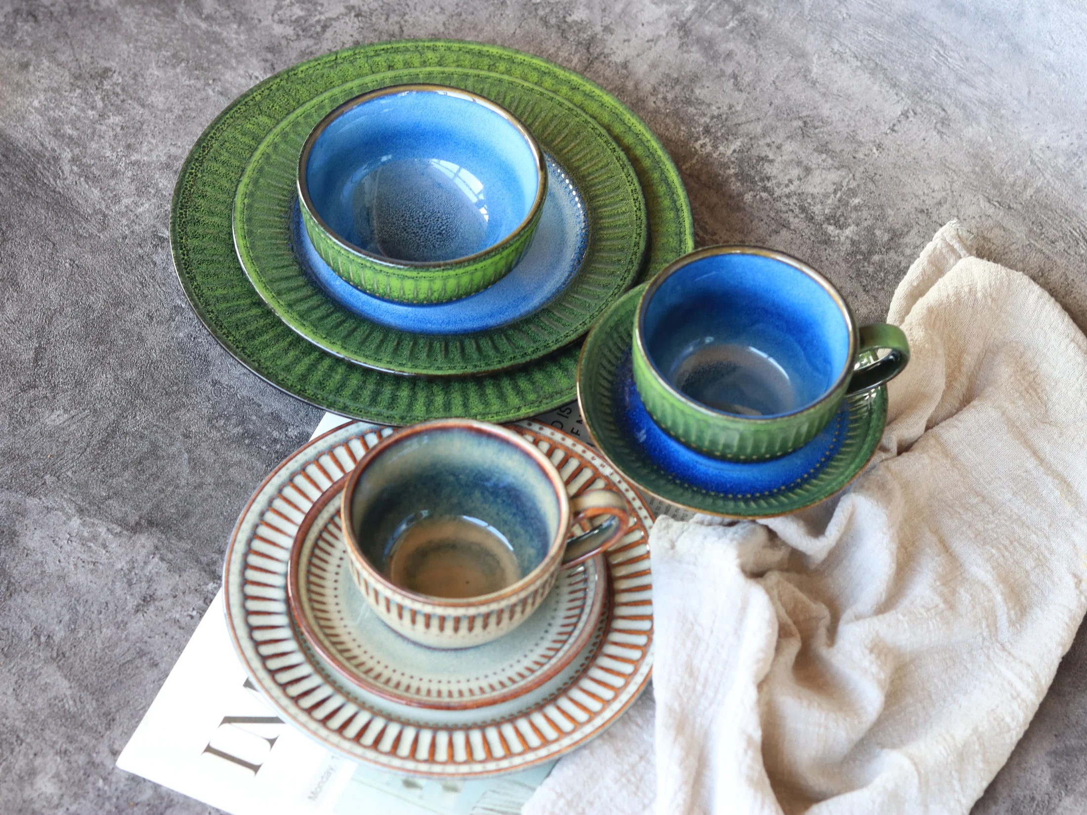 Ribbed cups and saucers in green and blue colouring - product photograph