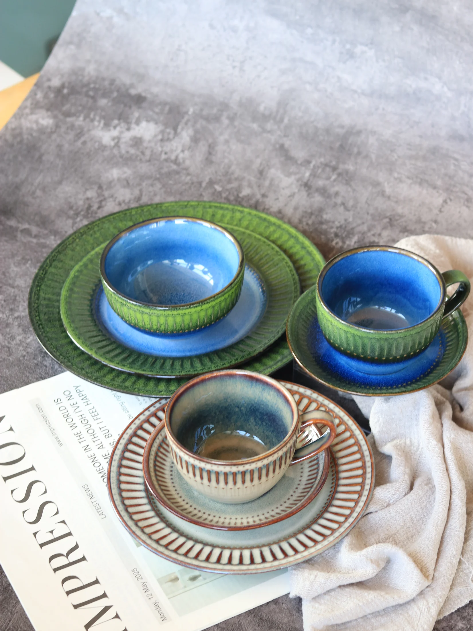 Ribbed cups and saucers in green and blue colouring - product photograph